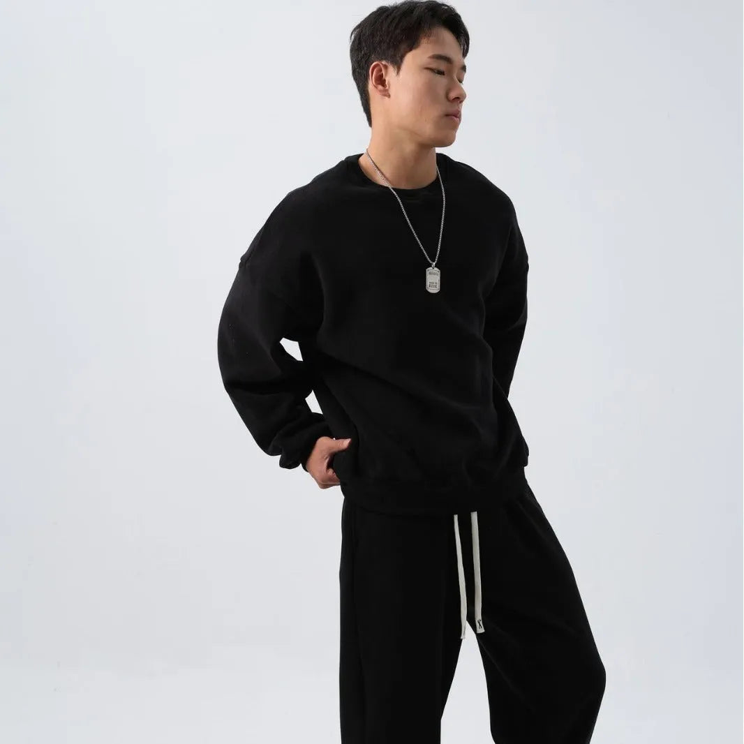 Men's polar fleece tracksuit set showing crew neck top with padded trousers in winter sportswear style