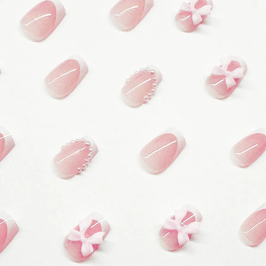 Short white French artificial nails with bow and tulip designs in European square shape