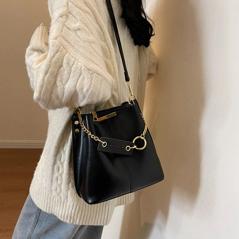 Large capacity PU shoulder bag with wide strap in black colour, sewing thread detail, crossbody style