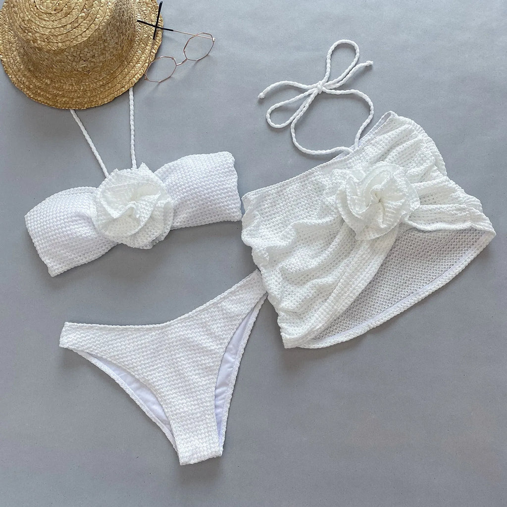 Women's white three-piece bikini set with skirt, bra, and briefs for swimming