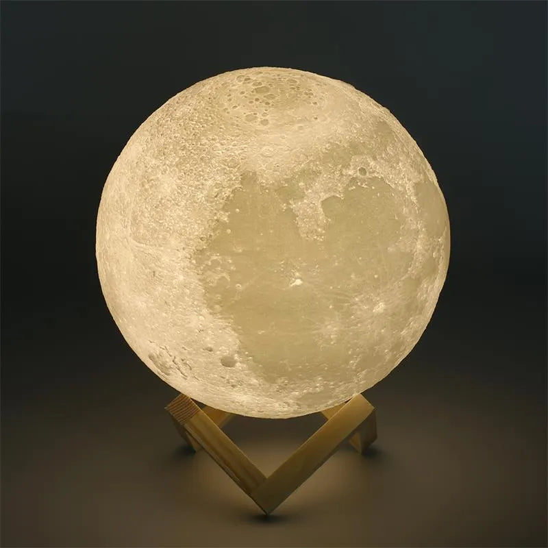 3D printed white moon lamp on a wooden stand, showing detailed lunar surface texture.
