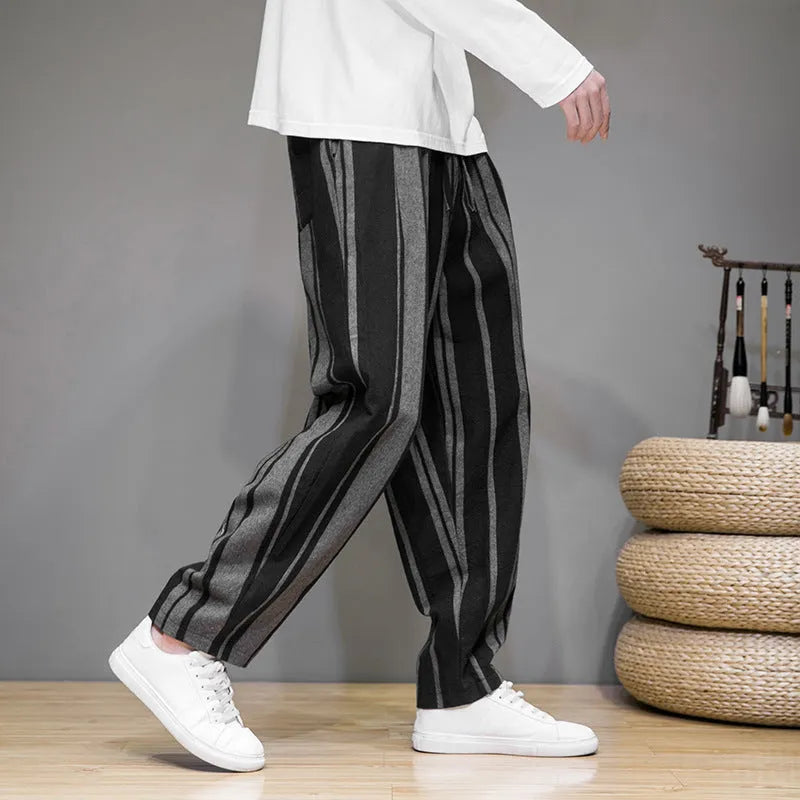 Men's navy blue and black striped wide-leg casual trousers with mid waist, laid flat.