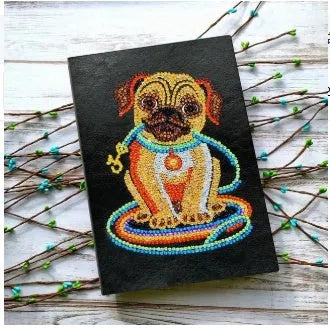 Black A5 diamond painting notebook, 142x207mm, with 50 blank pages open.