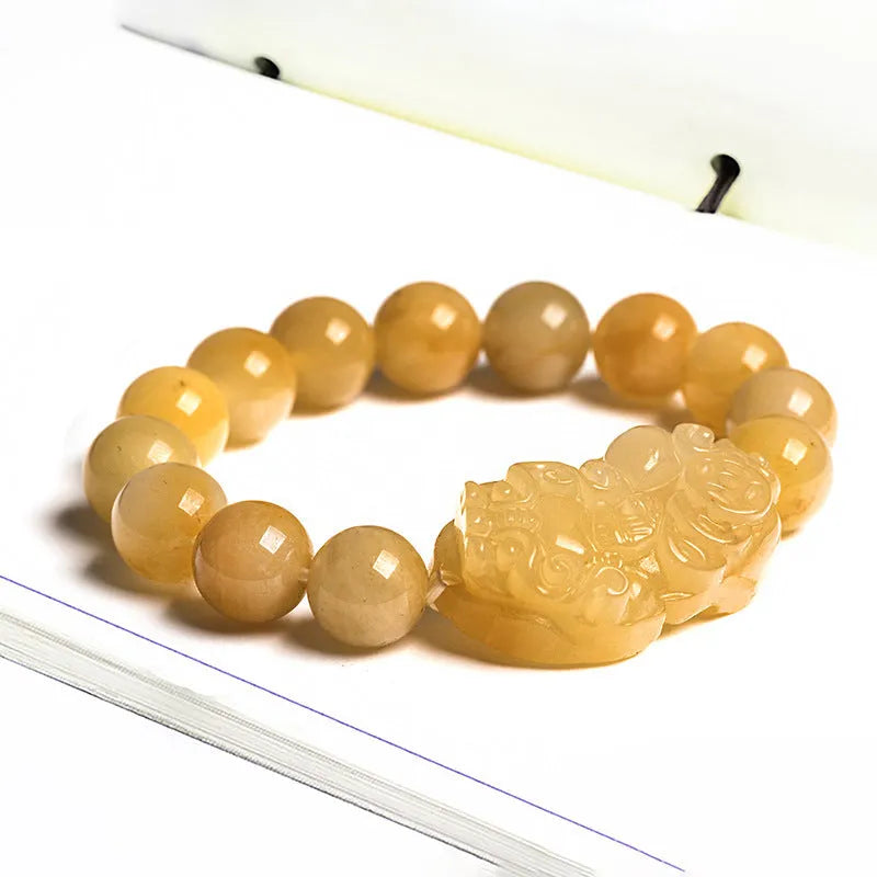 Personalised carved Golden Thread Jade bracelet showing bead detail and size comparison.
