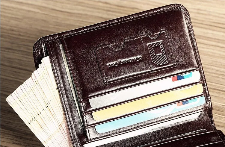 Men's compact leather wallet open showing card slots, change pouch, photo slot, and dark privacy compartment.