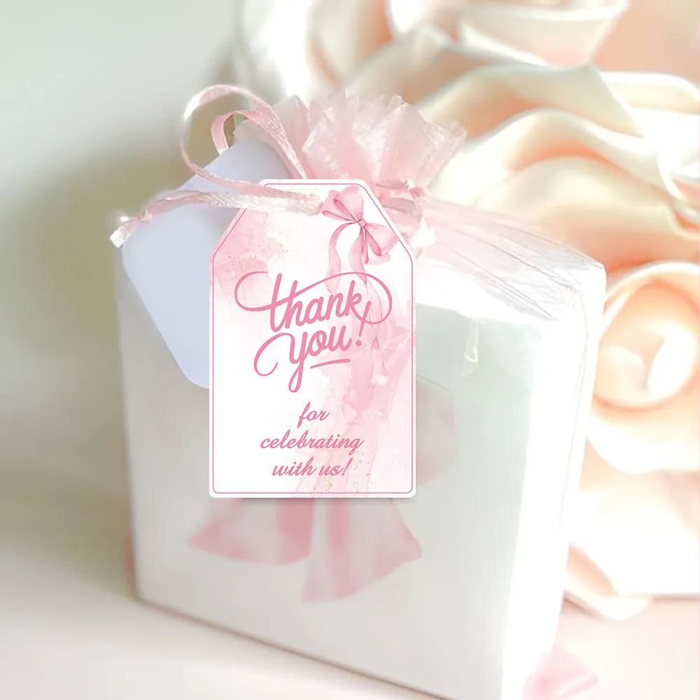 Set of 60 decorative bowknot-shaped paper gift tags with natural jute twine for birthdays.