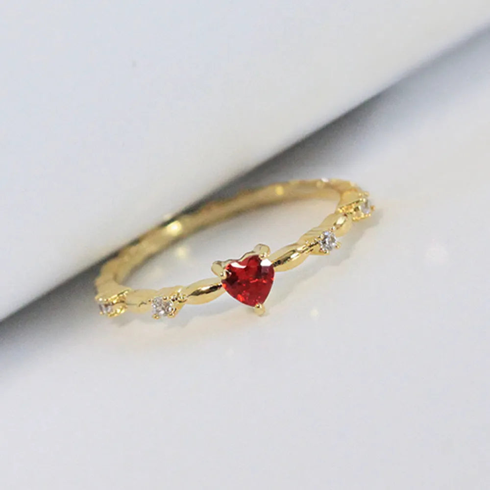 Personalised zircon peach heart ring in gold or silver finish on a copper band.