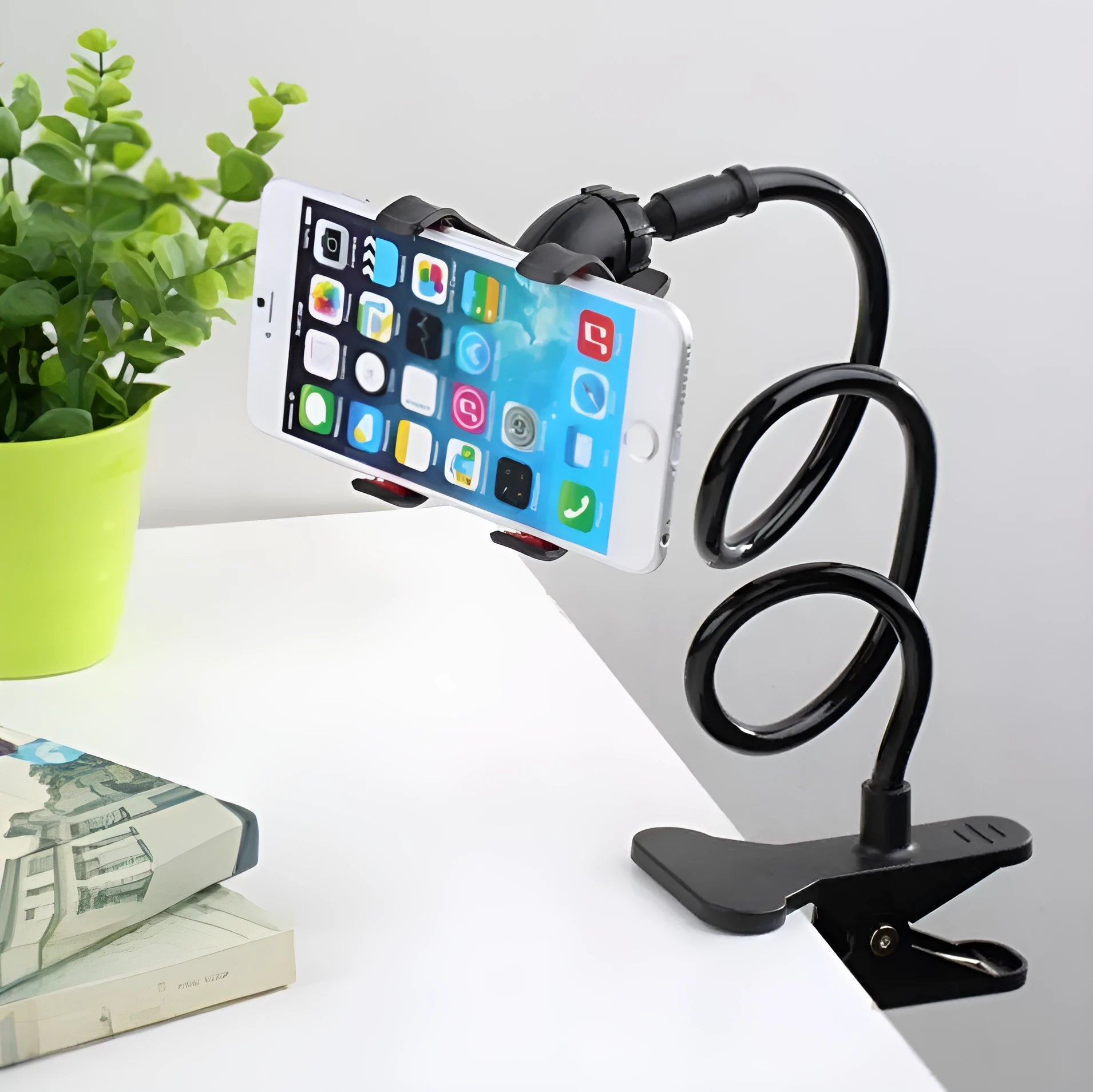 Black universal phone holder with long 70cm flexible arm and V-type clip, mounted on a bed frame.