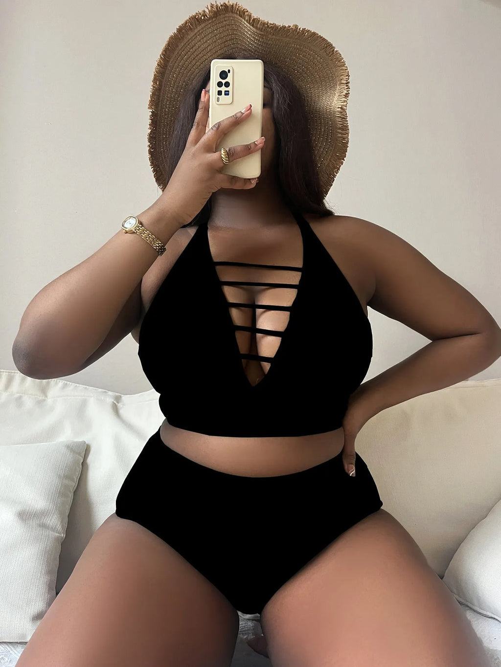 Plus size woman in black adjustable halter bikini with high-waisted briefs.