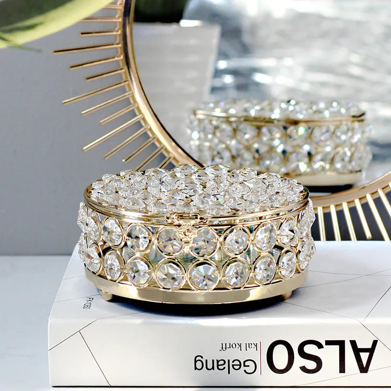 French gold iron frame crystal glass jewellery box with a metal lock closed.