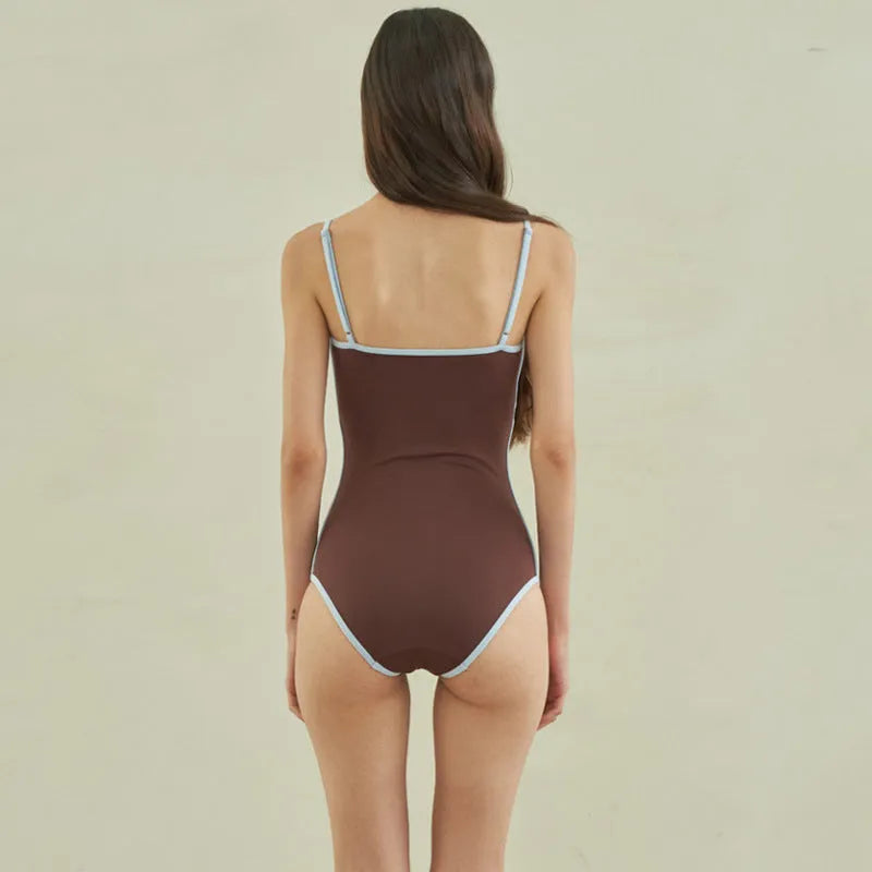 Brown women's one-piece triangle top swimsuit on hanger