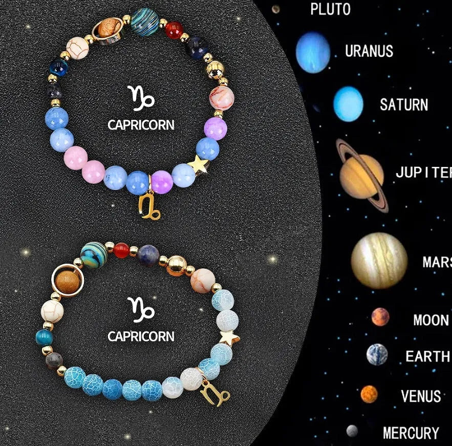 Two natural stone beaded bracelets showing zodiac sign designs on a wooden surface.