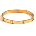 Stainless steel bracelet with a micro-inlaid peach heart charm in a golden electroplated finish.