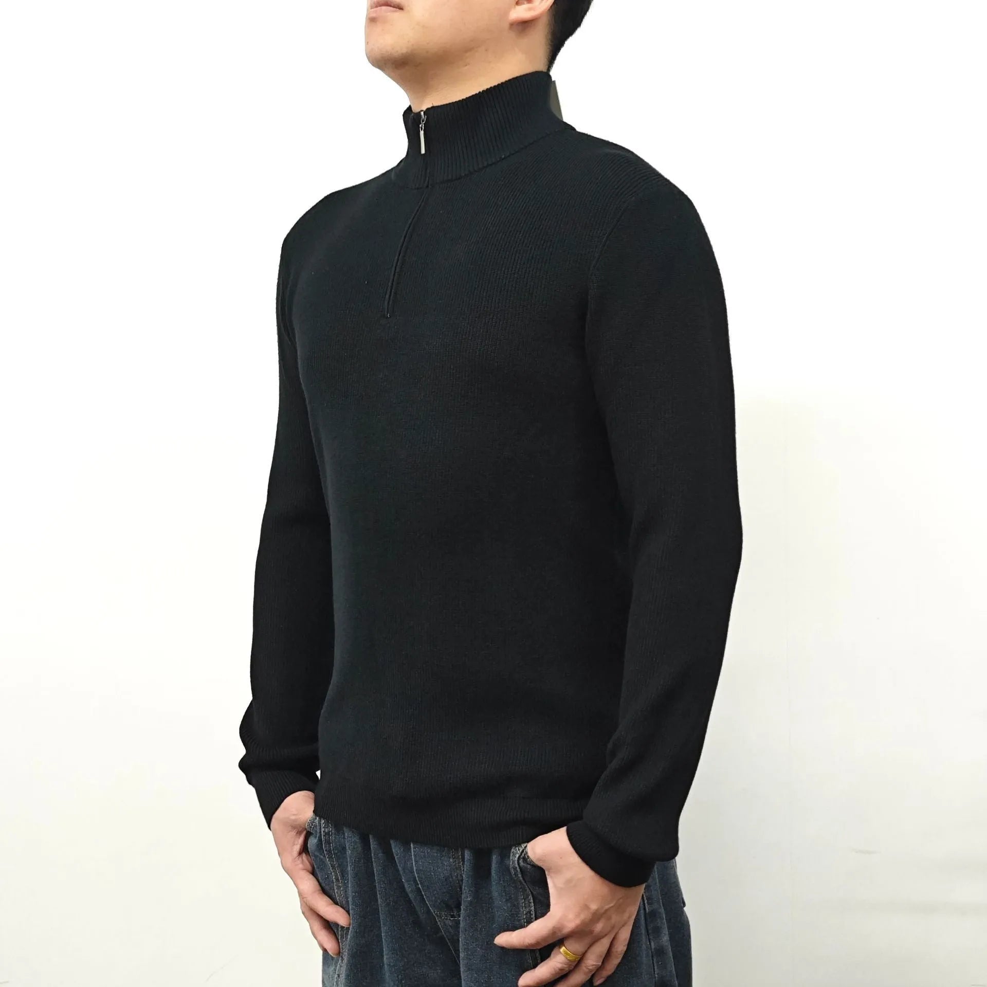 Man wearing a grey half turtleneck zipper sweater, a British style cotton blend pullover for spring.