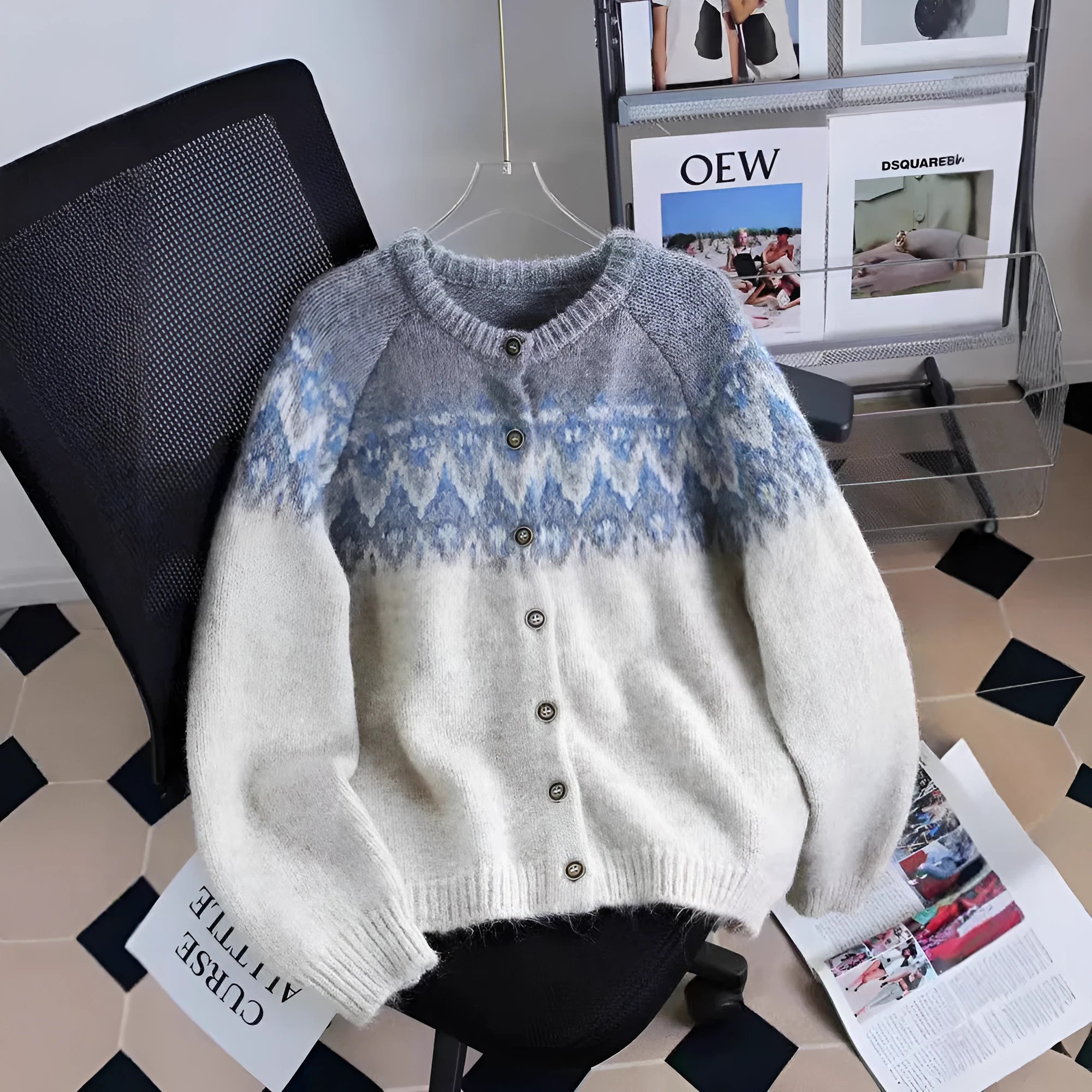 Women's beige jacquard knit sweater coat with contrast pattern, shown on a hanger.