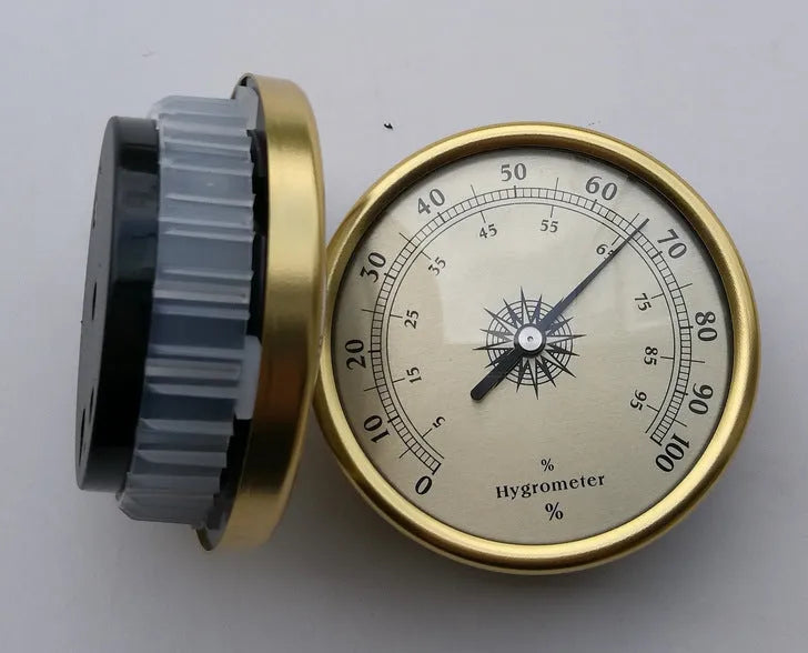 Circular analogue thermometer and hygrometer with aluminium outer ring and dial showing temperature and humidity scales