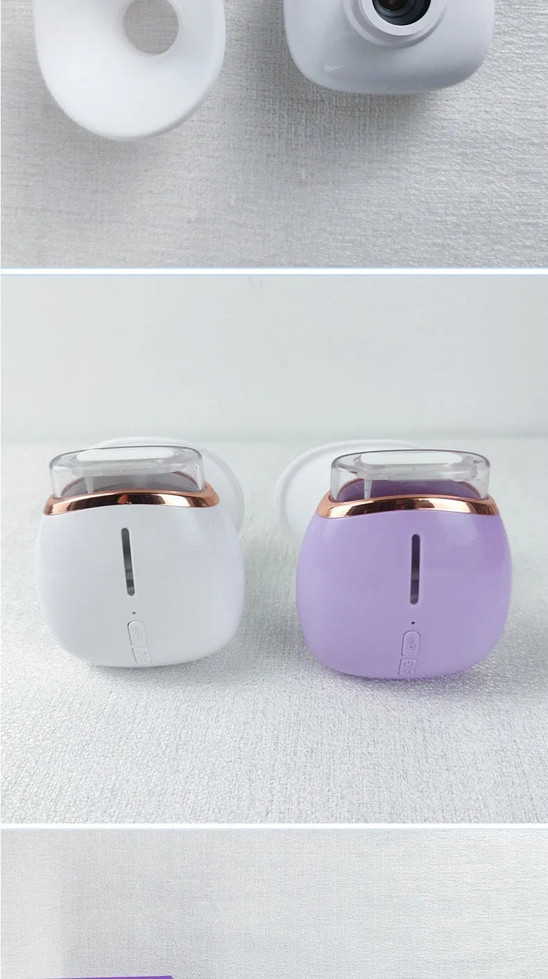 White and purple household eye humidifier with USB charging cable on wooden surface