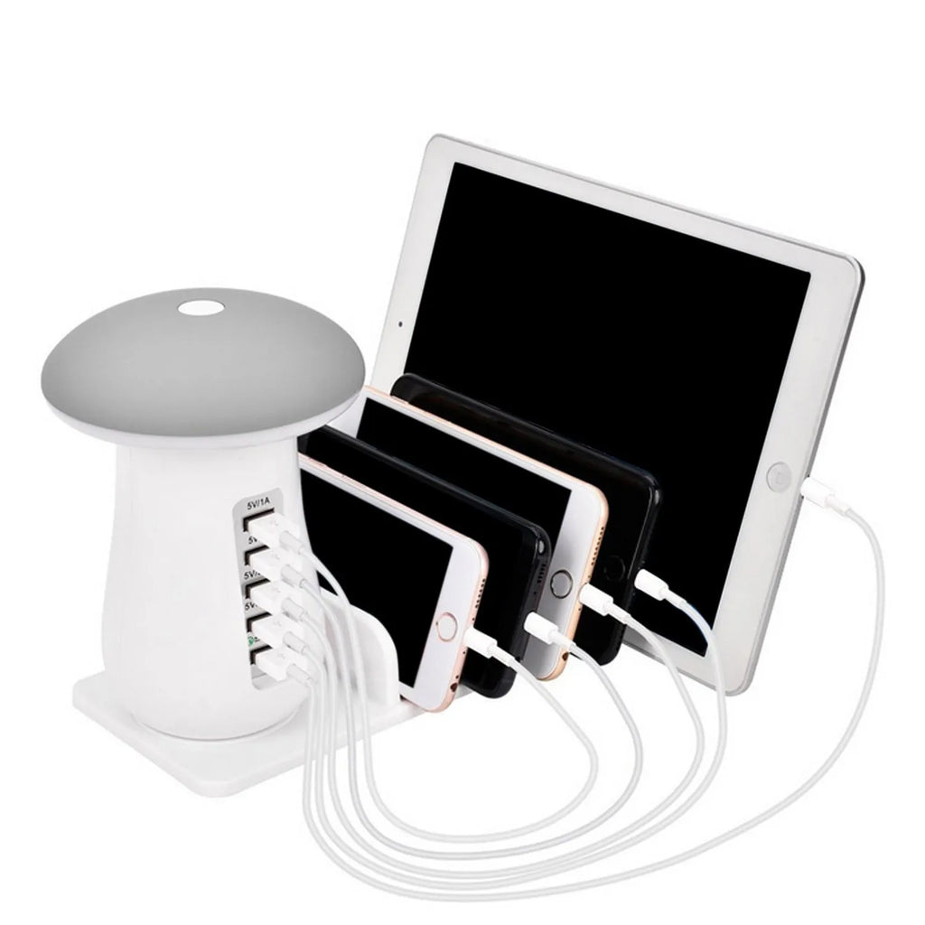 White mushroom-shaped LED desk lamp with 5 USB charging ports at its base on a wooden table.