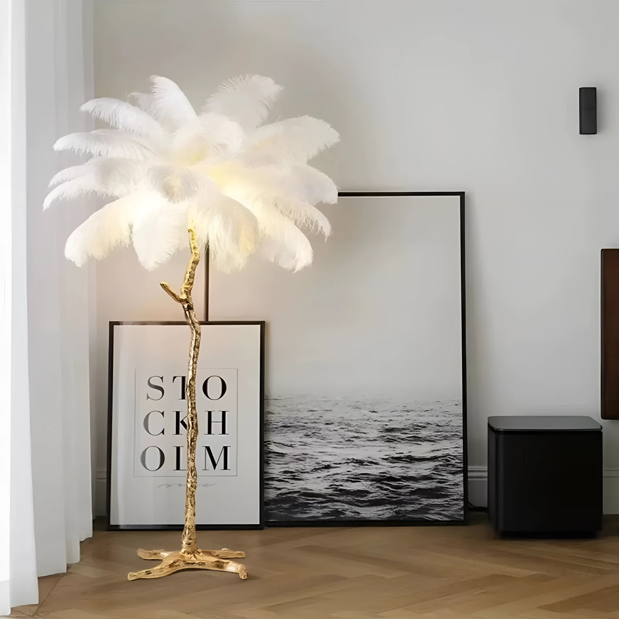 Tall decorative floor lamp with many white resin feathers, standing in a living room corner.