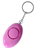 Egg-shaped personal safety alarm keychain in pink with metal pin on a white background