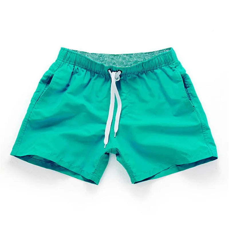 Men's straight-leg beach shorts in polyester fabric on a beach background
