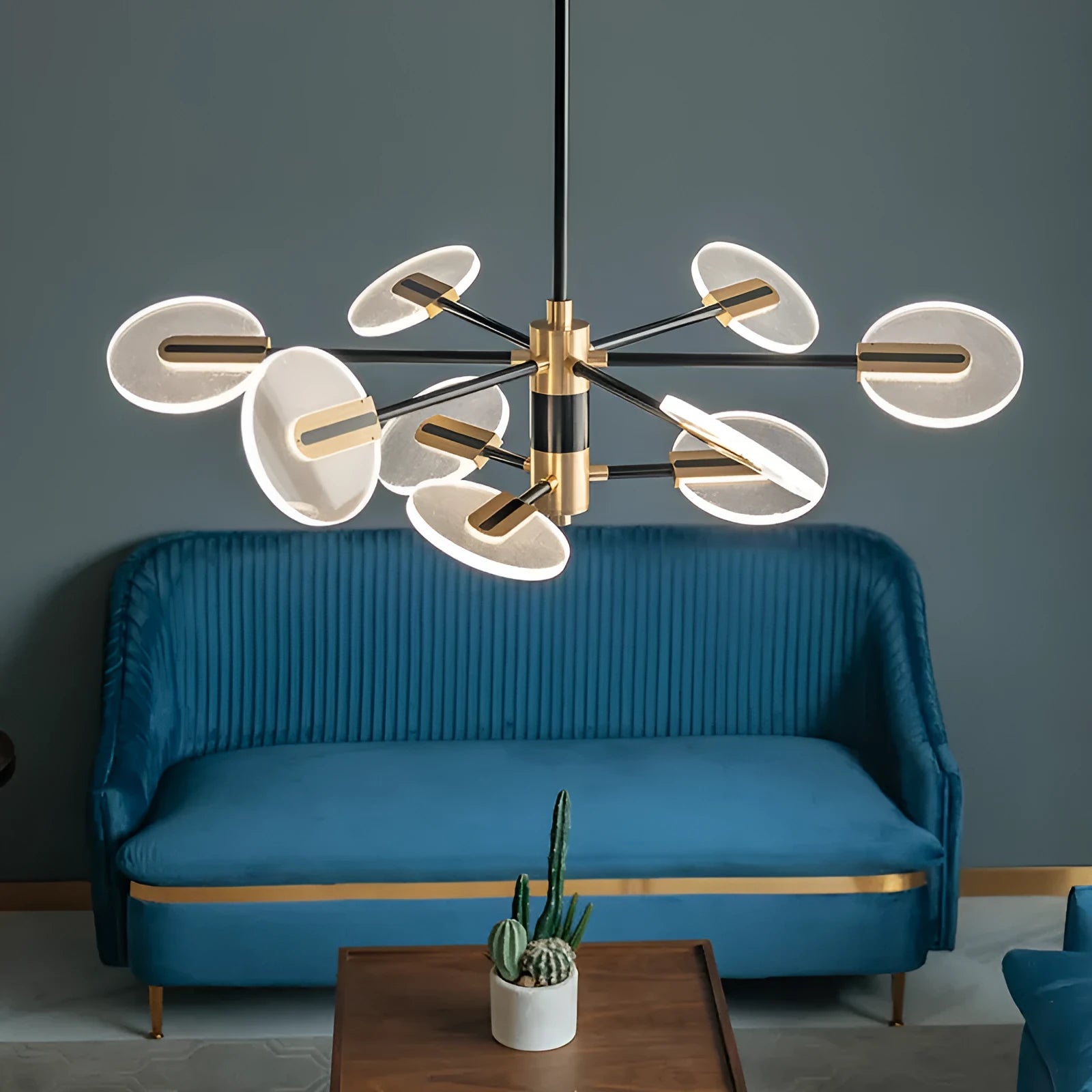 White iron frame LED chandelier with multiple acrylic shades hanging from ceiling