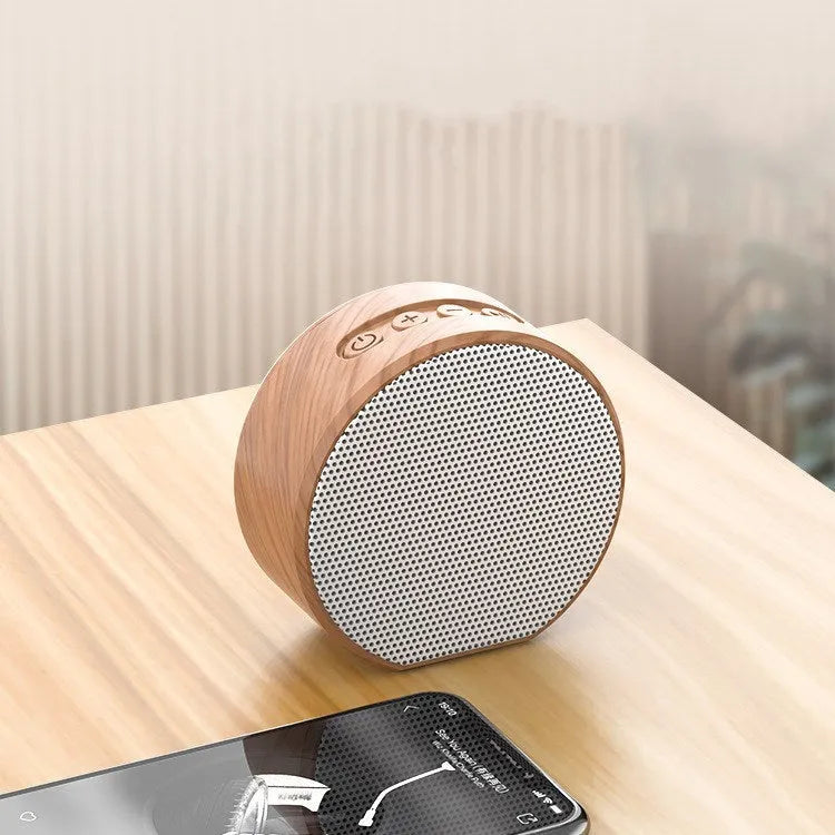 White wood grain Bluetooth speaker on a desk