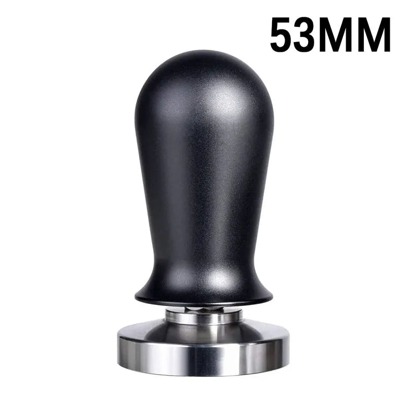 Black silicone pad coffee tamper with stainless steel base next to a red version on a counter.