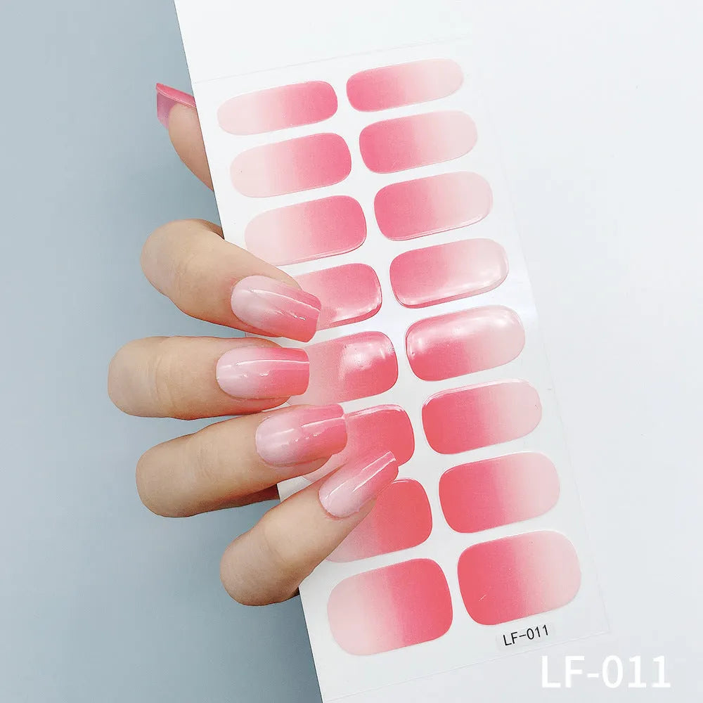 Full sheet of nail art stickers showing sixteen small designs including cross, rose, tulip, and leopard print patterns.
