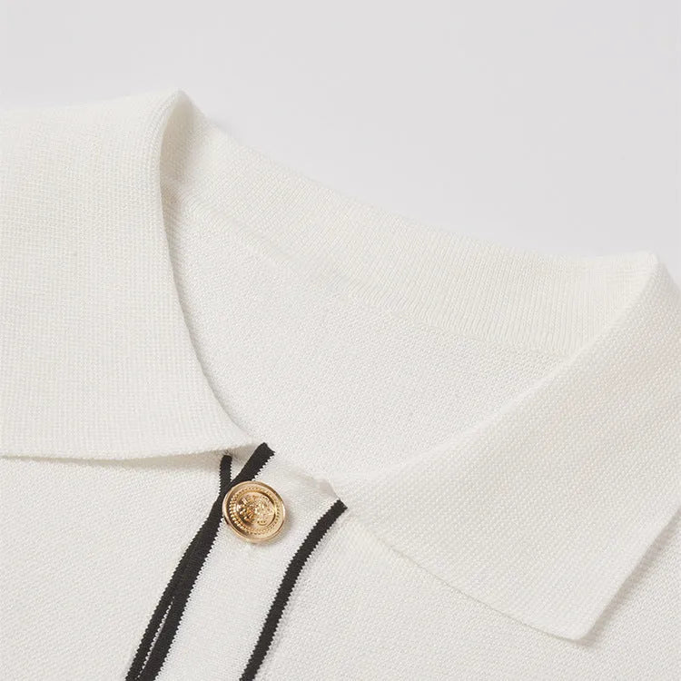 White cardigan with dark contrast lapels and short sleeves, laid flat.