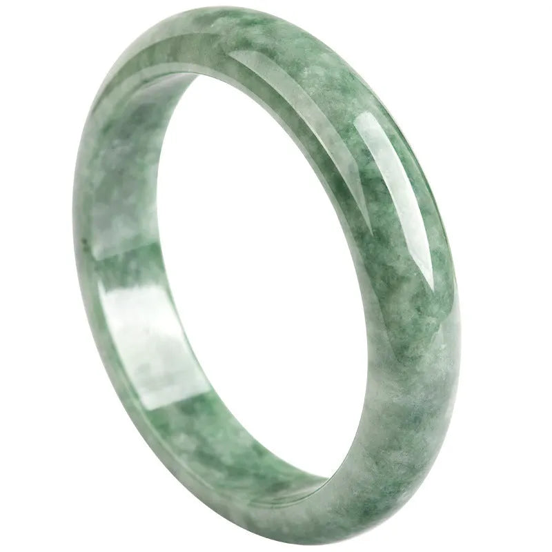 Natural deep pea green emerald stone bracelet on a wrist, showing its simple band design.