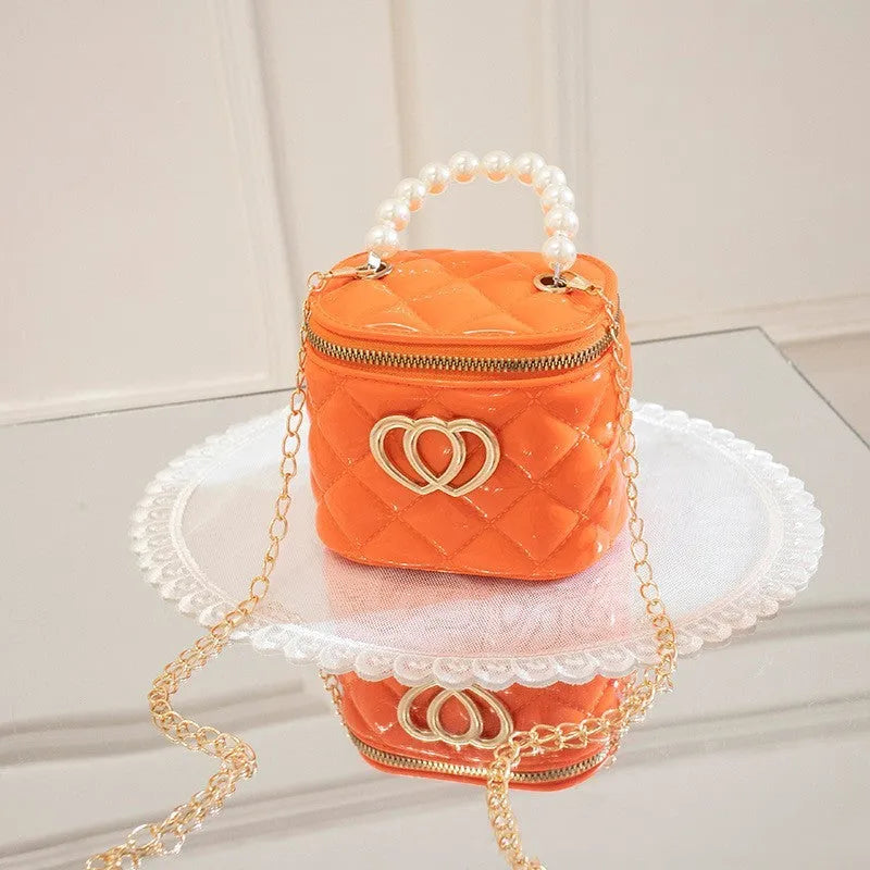 Women's white PVC bucket gel handbag with a red heart-shaped pattern lining.