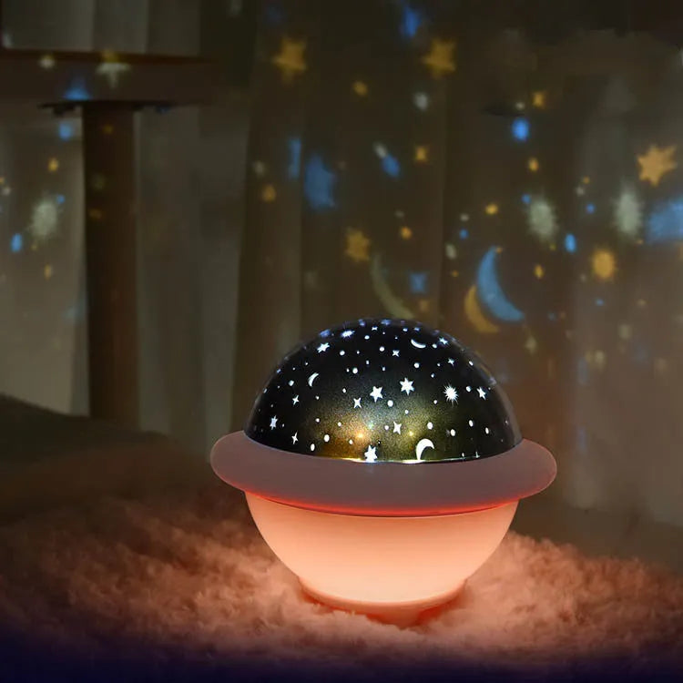 Green UFO shaped LED night light projecting starry sky pattern on ceiling