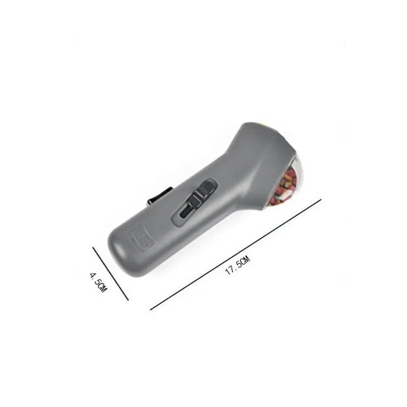 Grey pet snack launcher toy measuring 18cm with spring trigger mechanism for 2-3 metre treat launching