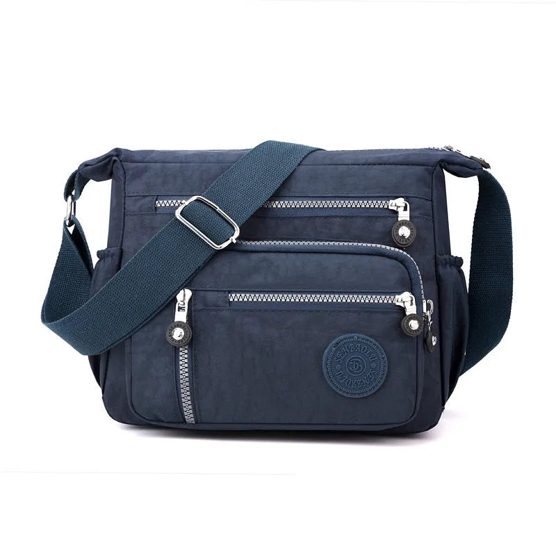 Grey lightweight nylon messenger bag with large capacity and single shoulder strap.