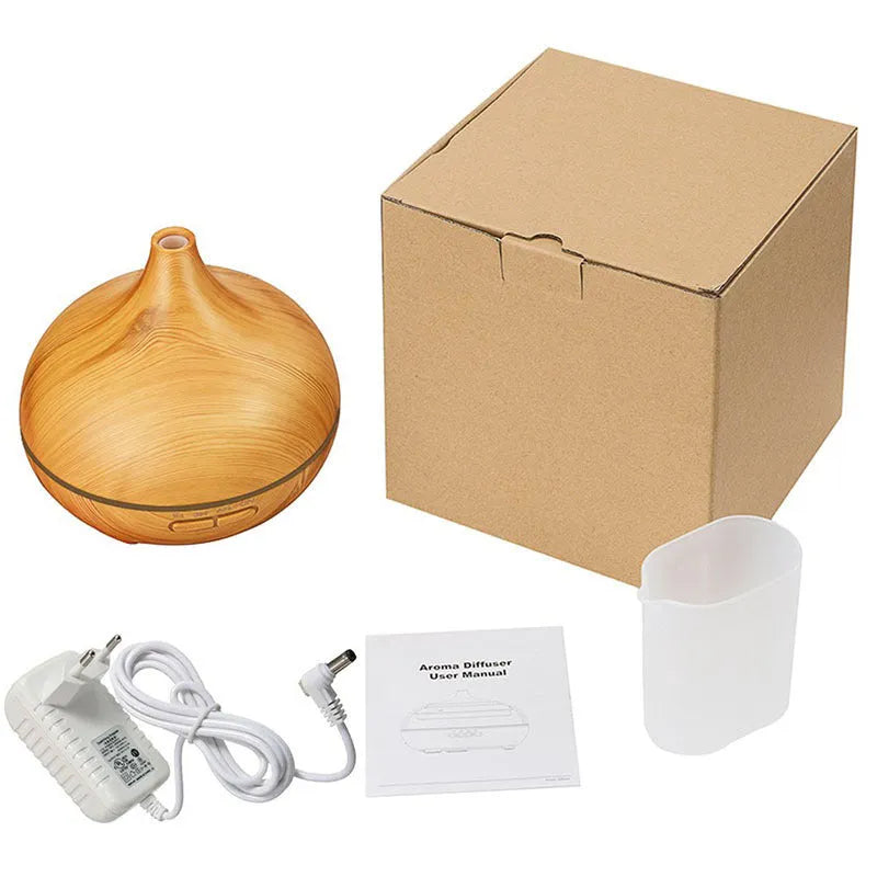 Round 550ml ultrasonic aromatherapy humidifier in white with mechanical control on desk