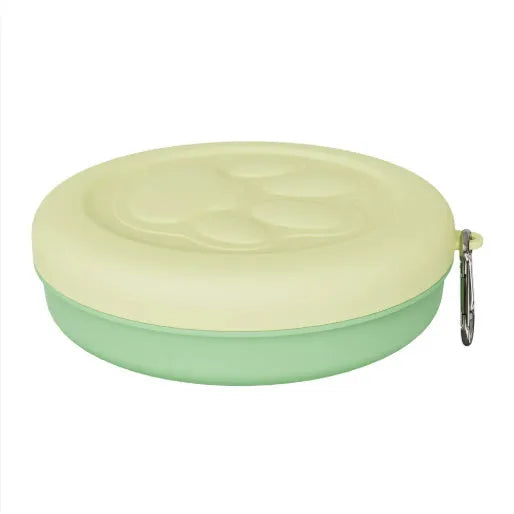Portable outdoor dog bowl set in light green and pink, showing food bowl, water dish, and snack box compartment.