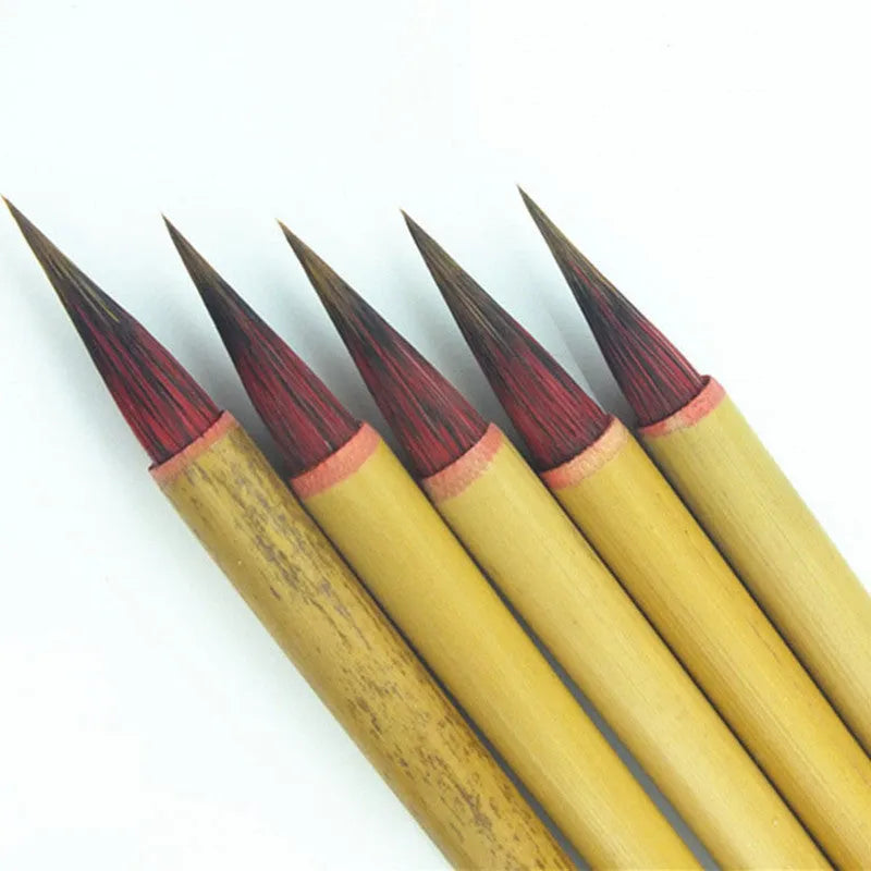 Small red writing brush with mixed sheep and wolf hair bristles on wooden handle