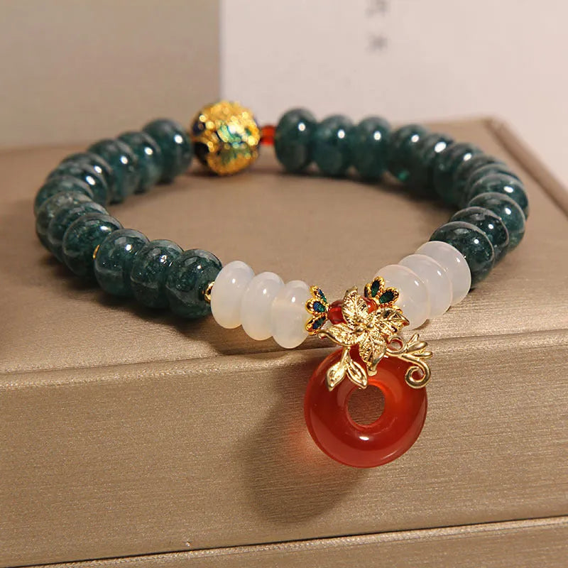 Blue water jade and red agate bracelet with peace buckle charm and rhinestone details