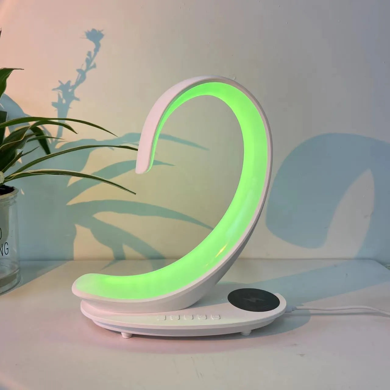 White swan-shaped desktop wireless charger with Bluetooth speaker and colourful LED atmosphere lighting