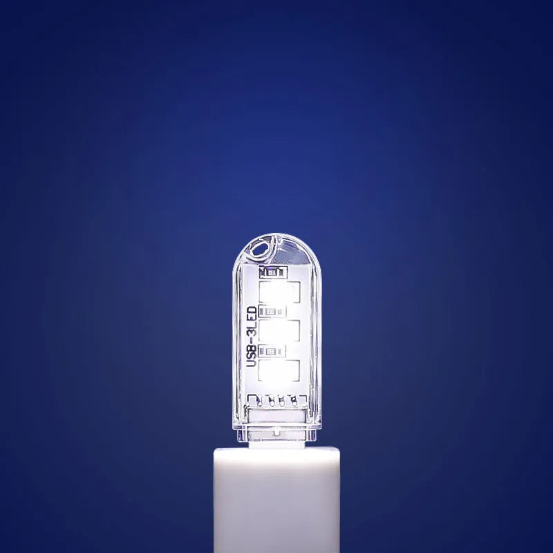 Small round USB baby night light showing warm and white light colour options