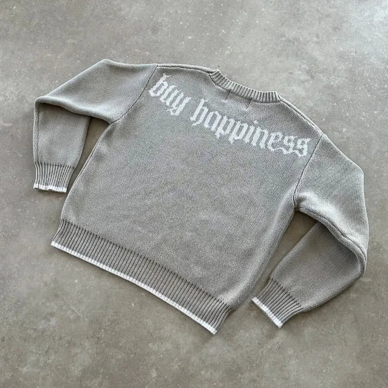 Grey loose-fitting jacquard knitwear coat with long sleeves on a hanger.