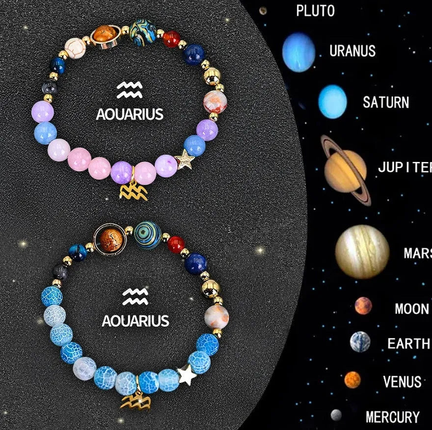 Two natural stone beaded bracelets showing zodiac sign designs on a wooden surface.