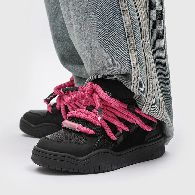 Pair of casual unisex lace-up shoes with thick rubber sole, shown in a choice of colours.