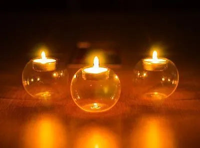 Hand-blown Europe style hollow glass candle holder in round design on table