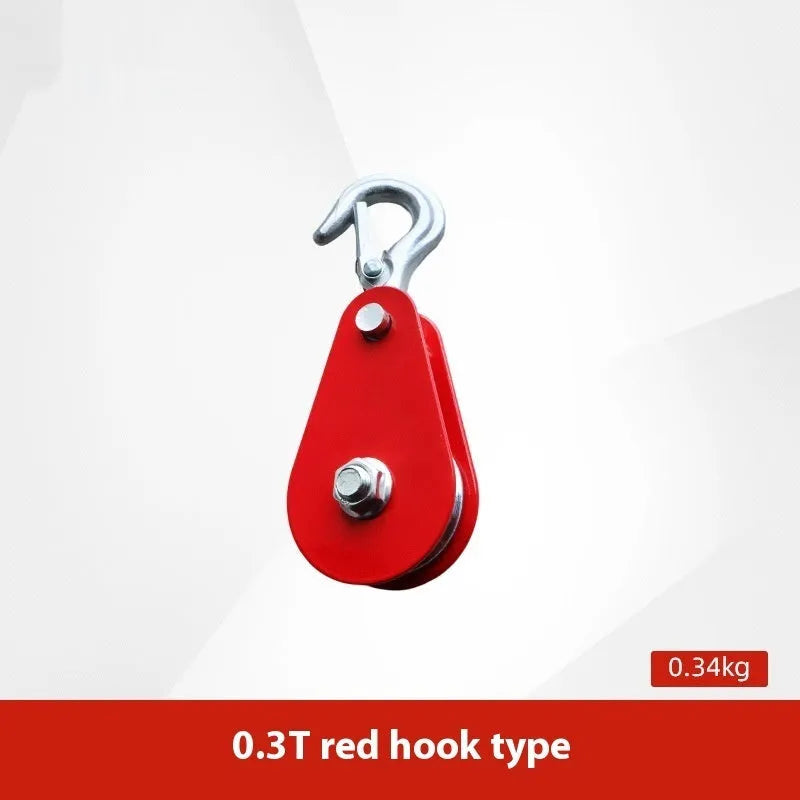 Red industrial steel lifting pulley with a safety latch on the hook.