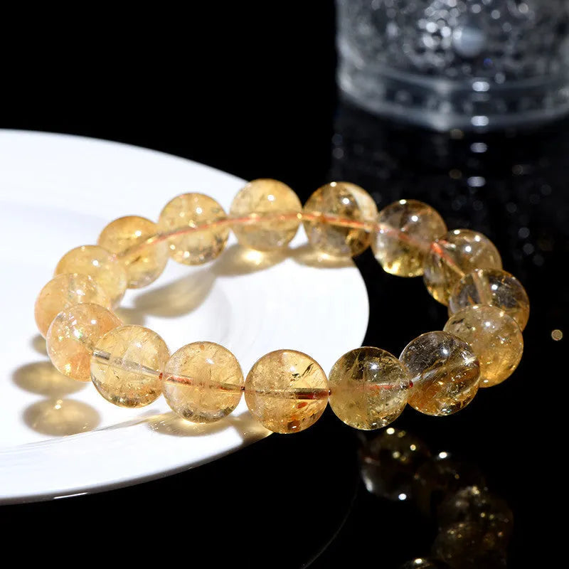 Natural yellow citrine gemstone bracelet showing geometric beads on a string.