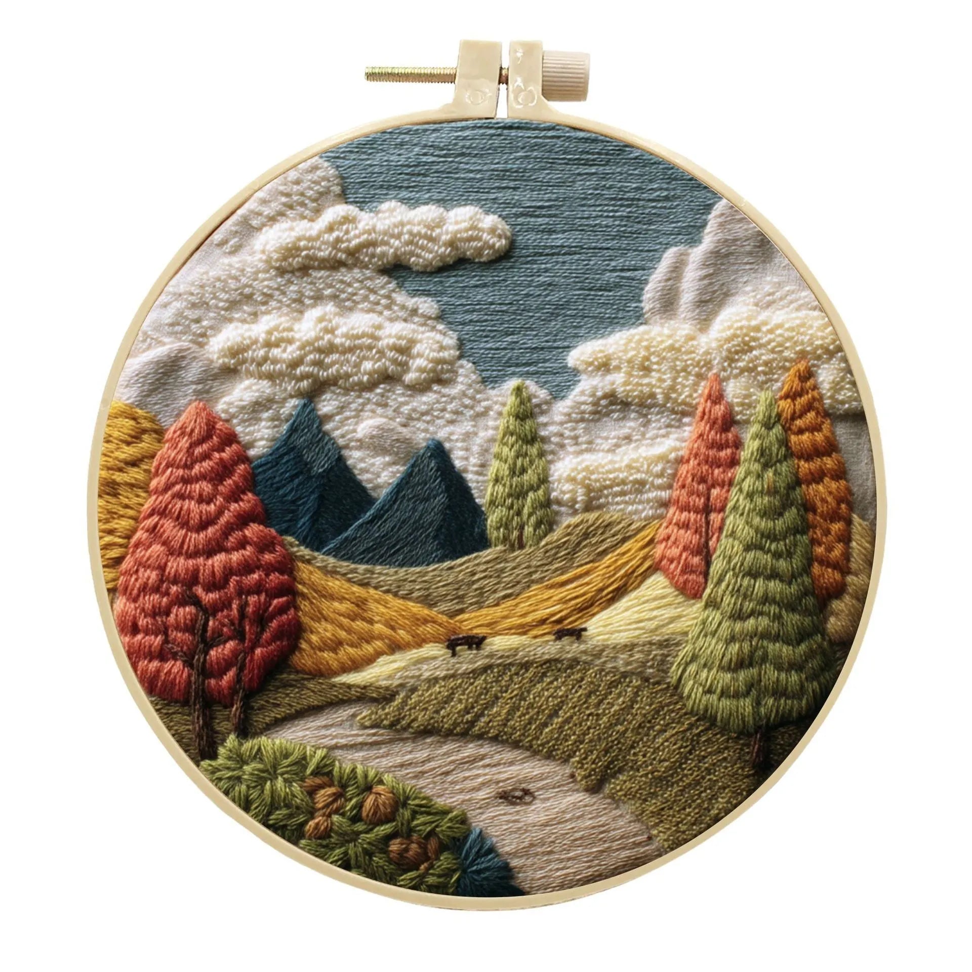 Embroidery DIY kit with bamboo frame, cotton fabric printed with a landscape scene, threads, and needles laid out