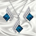 Glass and alloy necklace and earring set with cross chain styling and electroplated ornament details