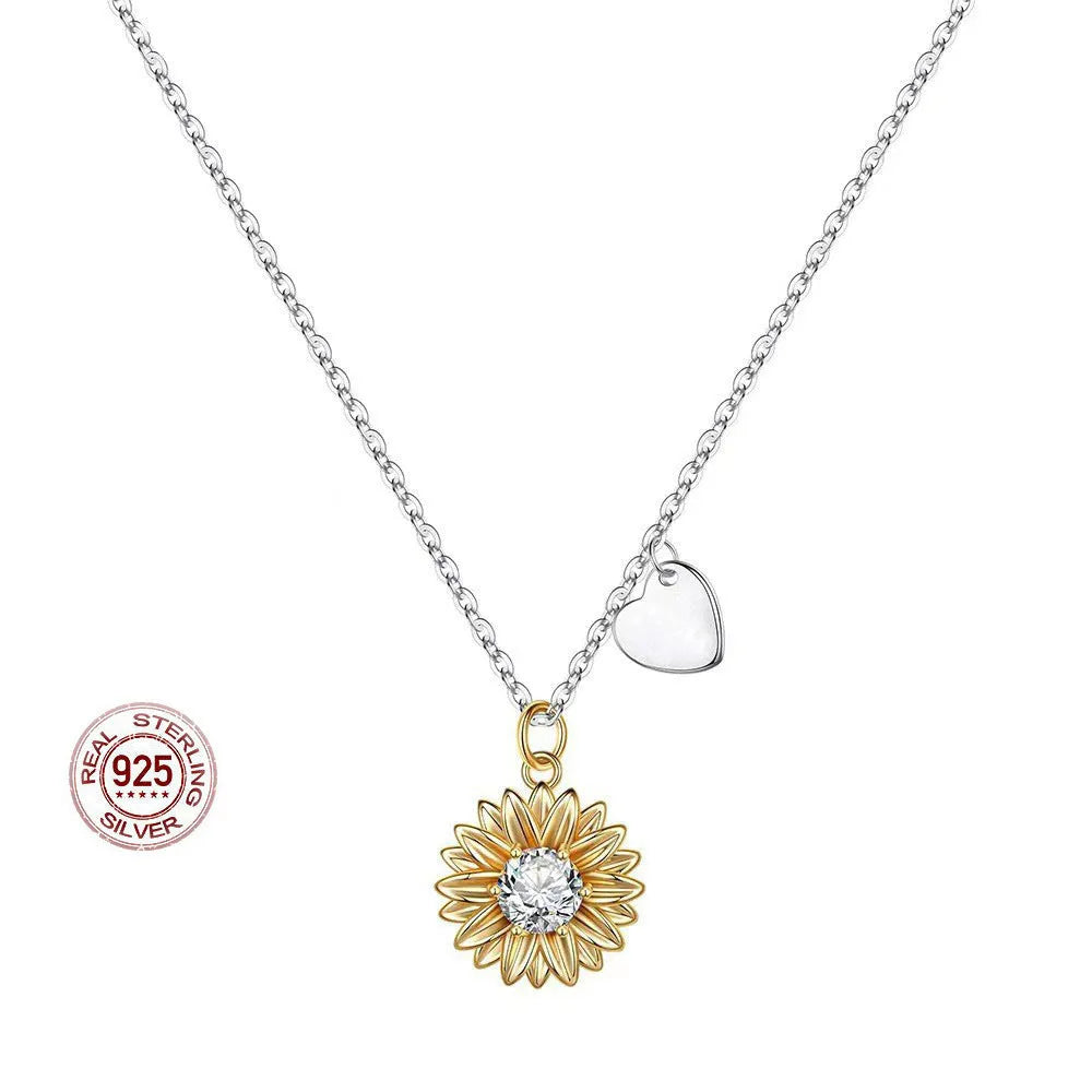 Close-up of a women's 925 silver necklace with a small daisy petal pendant on a cross chain, laid flat to show length.